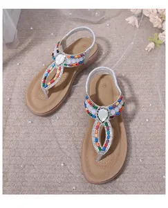 Detailed top view of flat thong sandals featuring colorful beads and pearl ornaments