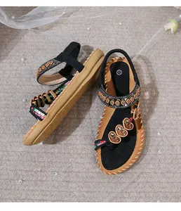 Detailed close-up of Bohemian flat sandals featuring embroidered straps and heart accents