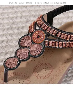 Detail of bohemian flat sandal with decorative shells, beads and sunflower textured footbed