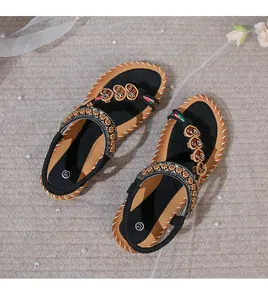 Macro detail of Bohemian flat sandals with ethnic beads, floral fabric, and size 37 label