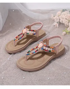 Detail of T-strap flip flop sandals with colorful beads and sparkly rhinestones