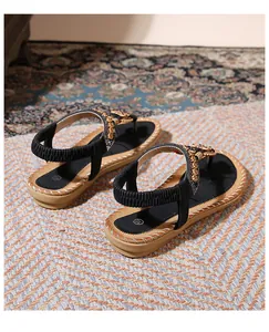 Detail view of Bohemian flat sandals with vintage circular metal decor and rhinestones
