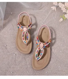 Close-up of bohemian flat sandals with colorful beads, sequins, and gemstone details