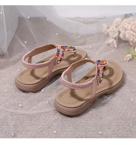 Detail view of Bohemian flat sandals with colorful beads, sequins, and elastic heel strap