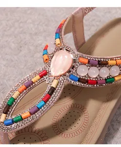 Close-up of bohemian sandal with colorful beads, rhinestones, and gemstone detail