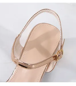 Macro detail of champagne gold leather ankle strap and metal buckle on high-heeled sandals