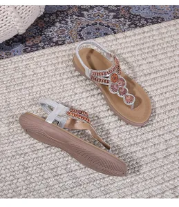 Detail of bohemian flat sandal showing intricate gold beadwork and size 37 on the insole
