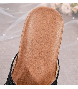 Detailed macro view of comfortable brown footbed with elegant black woven strap edge