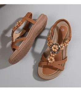 Détail de sandales bohèmes avec lanières à fleurs perlées et taille 37 sur semelle brune