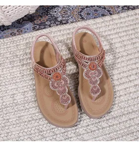Detailed top view of Bohemian flat sandals with sparkling beads and ethnic metal decor