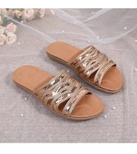 Detail showing wave-patterned gold sequin straps on comfortable flat summer sandals