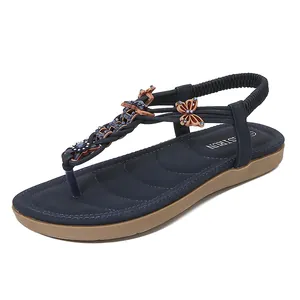 Sandalias planas de mujer con tira en T azul oscuro, pedrería de mariposa y correa elástica