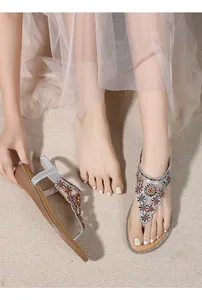 Close-up of Bohemian wedge sandals featuring colorful rhinestones and floral beadwork