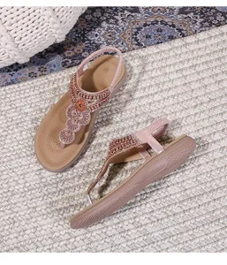 Detailed close-up of Bohemian T-strap flat sandals with rhinestones and beaded flower pattern