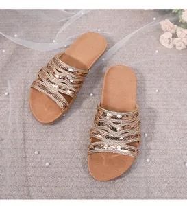 Close-up of rose gold sequined braided straps on bohemian flat sandals for women
