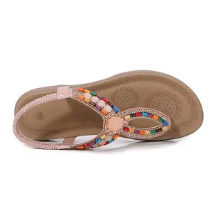 Bohemian flat sandals for women featuring T-strap design with colorful beads and pink stone