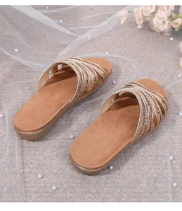 Detailed view of bohemian gold braided straps on comfortable flat summer sandals