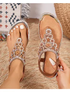 Close-up of bohemian rhinestone flat sandals with crystal flowers and elastic back strap