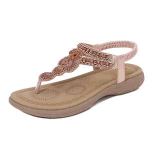 Women bohemian flat sandals with rose gold straps, shell ornaments and bead accents