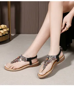 Detail of bohemian sandals featuring colorful rhinestones on a T-strap with glitter sole