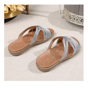 Close-up of bohemian silver woven straps and rhinestones on women flat slide sandals