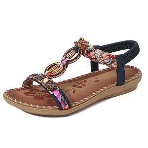 Sandali bassi bohémien blu navy con cinturino a T decorato con perline e fiori