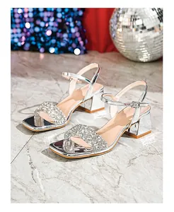 Detail of silver square toe block heel sandals with rhinestone straps and ankle buckle