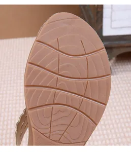 Detail of non-slip rubber outsole with curved traction patterns on bohemian flat sandals