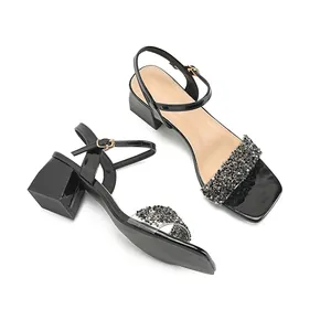 Women's black patent leather sandals with chunky heels and rhinestone strap