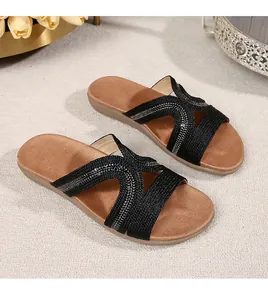 Detail shot of black braided straps with sequins on bohemian flat sandals for women