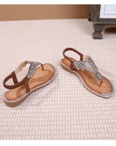 Detailed close-up of Bohemian sandals featuring intricate rhinestones and beaded T-strap