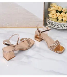 Rose gold platform sandals with rhinestone straps and square heel for a trendy look