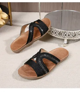 Flat bohemian sandals with rhinestone-embellished woven straps and soft brown footbed
