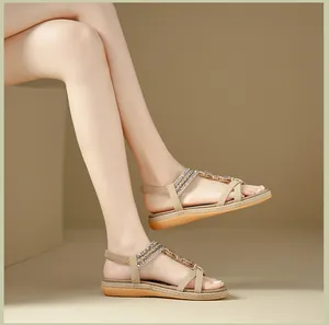 Detail of bohemian flat sandals featuring pearls, rhinestones, and elastic back straps