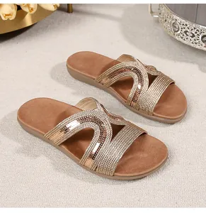 Detail of champagne gold woven straps with sequins on bohemian flat sandals
