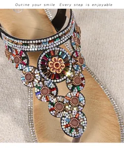 Detailed view of bohemian T-strap sandals with sparkling rhinestones and floral pattern