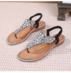 Macro detail of Bohemian T-strap flat sandals featuring sparkling crystal rhinestones