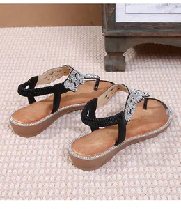 Detailed view of bohemian flip-flop sandals with sparkling rhinestone T-strap design