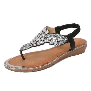 Bohemian black rhinestone flip-flop sandals with elastic heel strap and flat brown sole