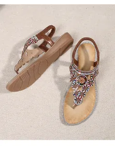 Macro detail of Bohemian flip-flop sandals with colorful beads and rhinestone floral patterns