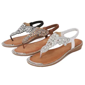 Flat bohemian T-strap sandals with rhinestone embellishments in black, brown and silver