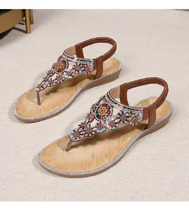 Macro detail of Bohemian T-strap sandals with colorful rhinestones and beaded flowers