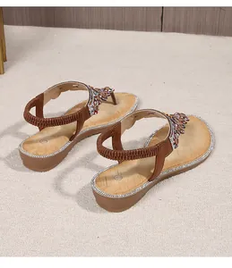 Detail of bohemian wedge sandal with colorful rhinestones and elastic heel strap