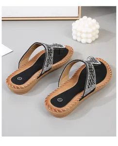 Detalle de sandalias planas bohemias con brillantes pedrería y lentejuelas negras