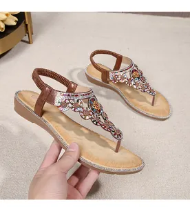 Close-up of bohemian wedge sandals with colorful rhinestones and beaded ethnic patterns