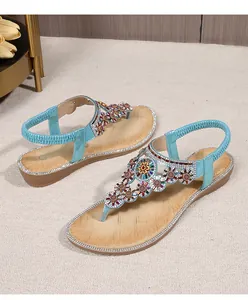Detail of bohemian wedge sandals featuring colorful beadwork and rhinestone floral patterns