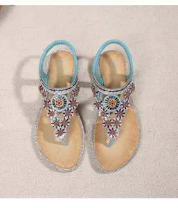 Close-up of Bohemian flat sandals with intricate beads, sequins and rhinestone edges