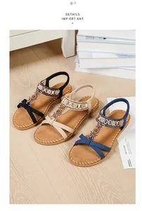 Detail of bohemian flat sandals with sparkling rhinestones, beads and elastic straps