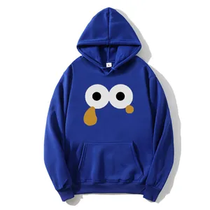 Detail of royal blue hooded sweatshirt featuring cartoon eyes graphic and kangaroo pocket
