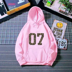 Detail of pink hoodie featuring leopard print number 07 and kangaroo pocket